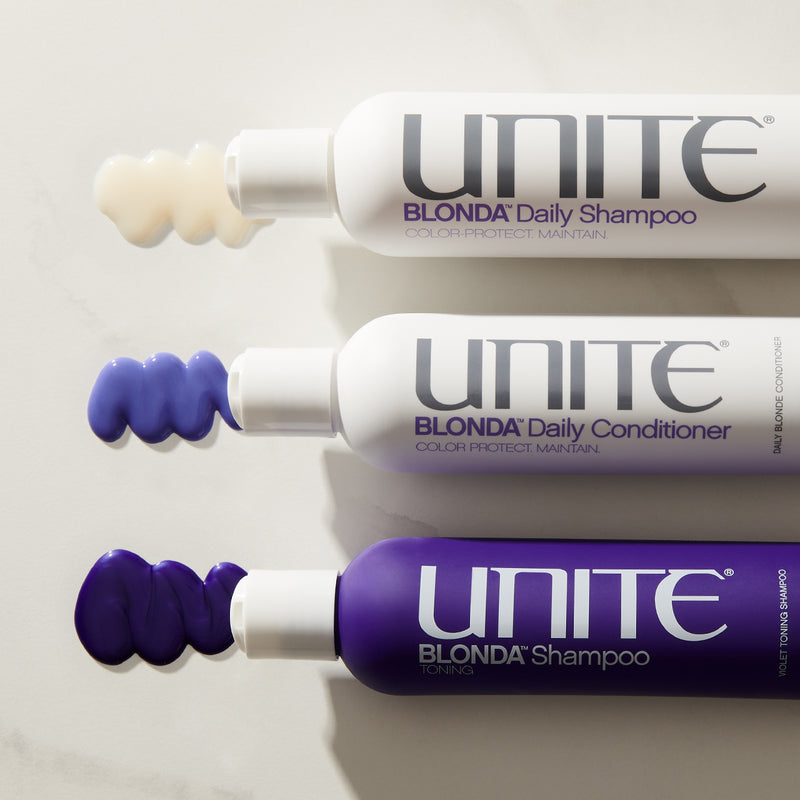 Bottles of Unite BLONDA Daily Shampoo, purple conditioner, and toning shampoo with swatches of each product on a white surface.