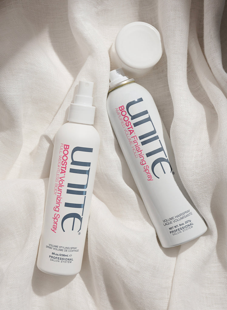 Bottles of volumizing spray and finishing spray for professional salon hair styling.